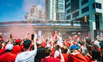 Canada-Qatar match fans underneath a TransLink SkyTrain overpass.
