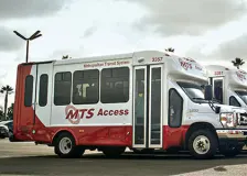 A lineup of four public transit vehicles.