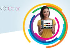 A woman holding a tablet with a screen showing rectangles of various colors