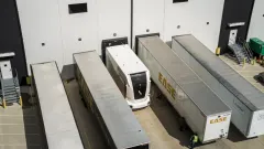Overhead view of an Einride autonomous electric truck positioned between trailers at an EASE Logistics warehouse loading area in Marysville, Ohio.