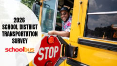School Bus Fleet's 2026 School District Transportation Survey graphic features a smiling school bus driver leaning out of a yellow bus beside its extended stop arm, with the survey title and publication logo.
