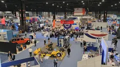 Overhead view of the APTA 2026 EXPO show floor at McCormick Place in Chicago, with attendees walking among exhibitor booths and gathering around APTA Central.