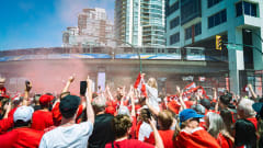 Canada-Qatar match fans underneath a TransLink SkyTrain overpass.