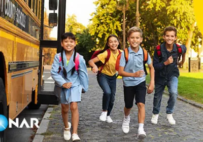 Image of happy school children exiting their school bus