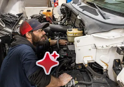 A man working on a truck engine.
