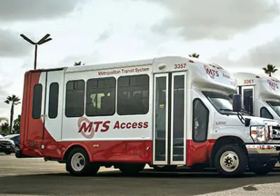 A lineup of four public transit vehicles.