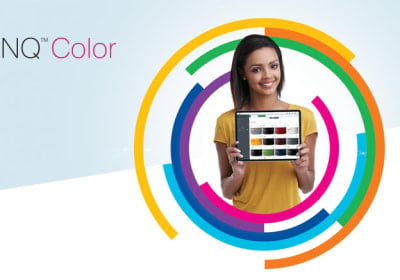 A woman holding a tablet with a screen showing rectangles of various colors