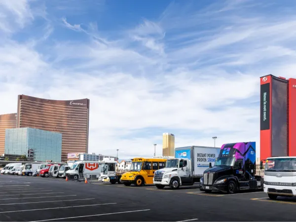 Commercial vehicles, including electric school buses and trucks, line up for ACT Expo’s outdoor ride-and-drive demonstrations in Las Vegas.