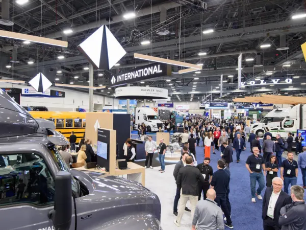 Attendees gather across the ACT Expo opening reception and exhibit hall featuring major commercial vehicle and electrification brands.