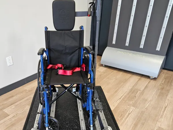 Wheelchair positioned in AMF Bruns FutureSafe securement system display inside showroom