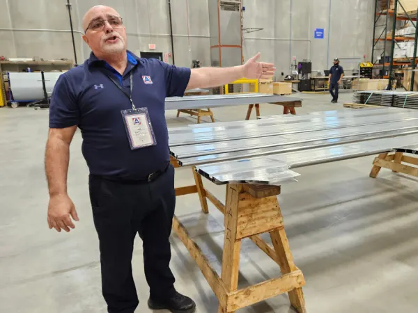 AMF Bruns employee leads tour of manufacturing floor and aluminum components