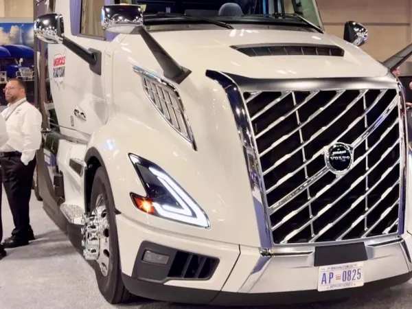 White Volvo heavy duty truck with America's Road Team logo