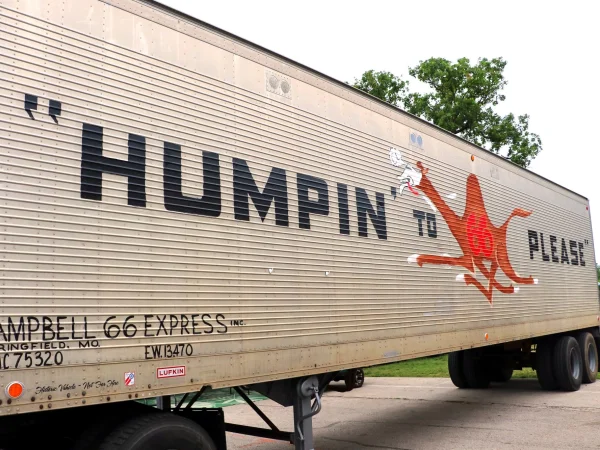 Vintage trailer with "Humpin to Please" and a running camel painted on the side