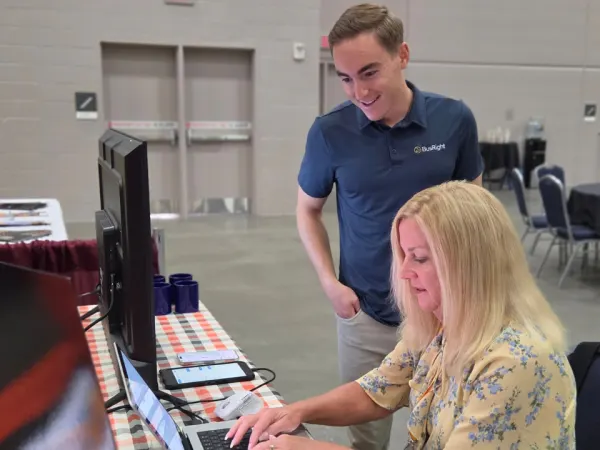 Keith Corso demonstrates the BusRight software to an attendee at NAPT ACTS 2026.