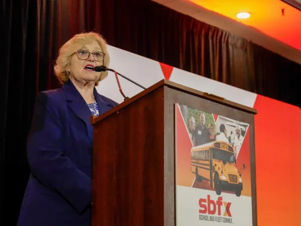 NAPT CEO and Executive Director Molly McGee Hewitt speaks from the podium during the 2026 School Bus Fleet ConneX.