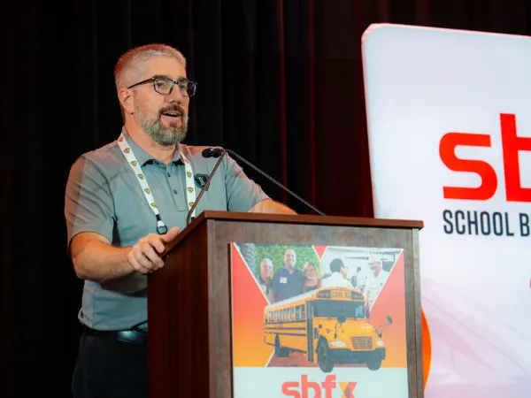 Chad Duncan speaks from the podium during an education session at the 2026 School Bus Fleet Connex event.