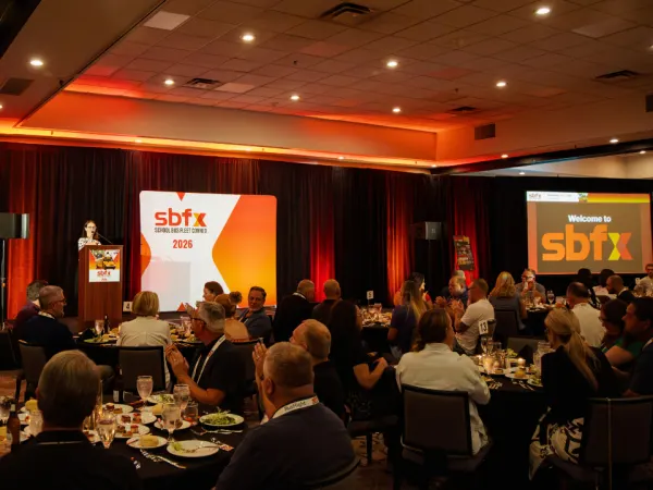 School Bus Fleet ConneX attendees gather around dinner tables during an evening program at the 2026 event in Scottsdale, Arizona.