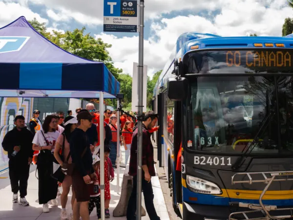 Fans board a TransLink bus displaying a “Go Canada Go” message during the World Cup.