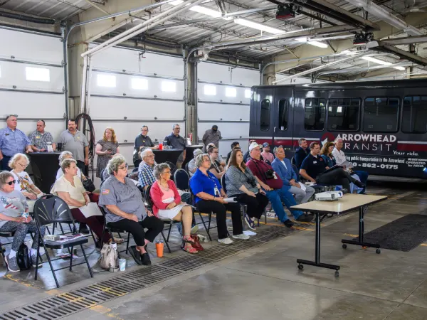 A presenter shared project details with the RideSmart 2025 launch event crowd.