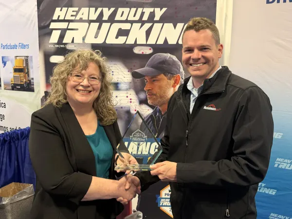 Man and woman shaking hands with Top 20 trophy between them