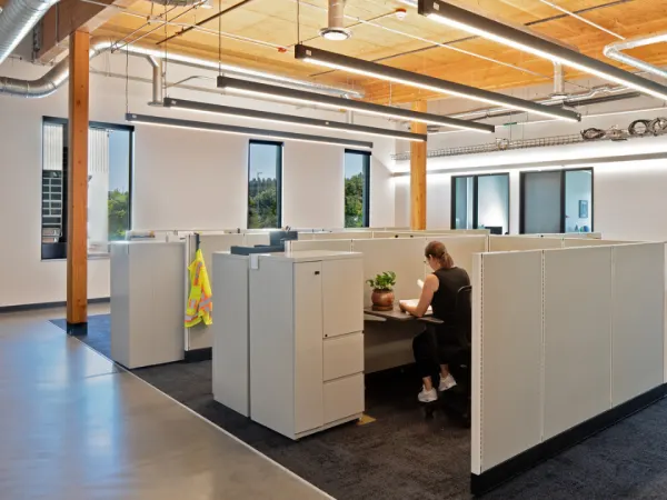 Interior image of C-TRAN's campus expansion work room with cubicles and timber ceiling.