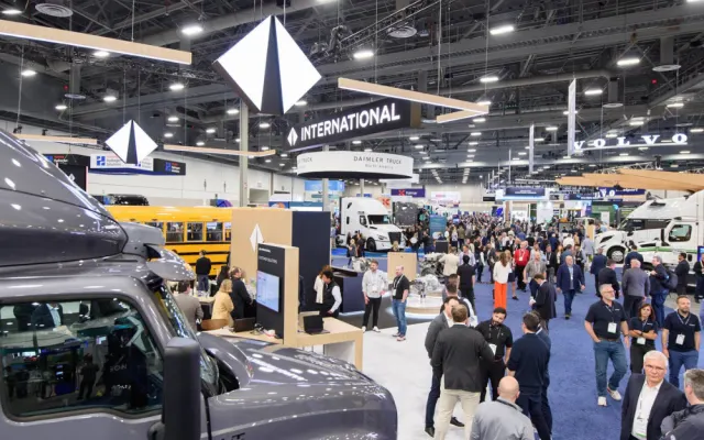 Attendees gather across the ACT Expo opening reception and exhibit hall featuring major commercial vehicle and electrification brands.