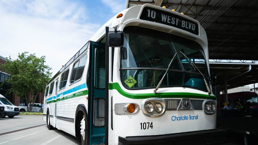 An preserved white and green older CATS transit bus.