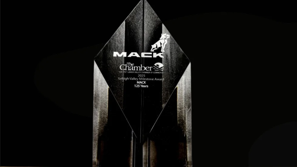 A clear crystal award engraved with “Mack” and “Lehigh Valley Milestone Award 2025 – Mack 125 Years,” displayed against a black background.
