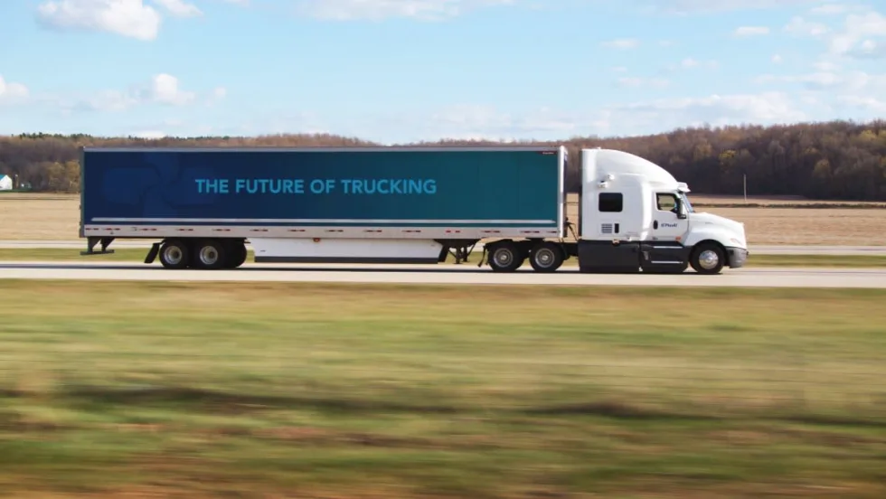 PlusAI autonomous truck with trailer going down a highway