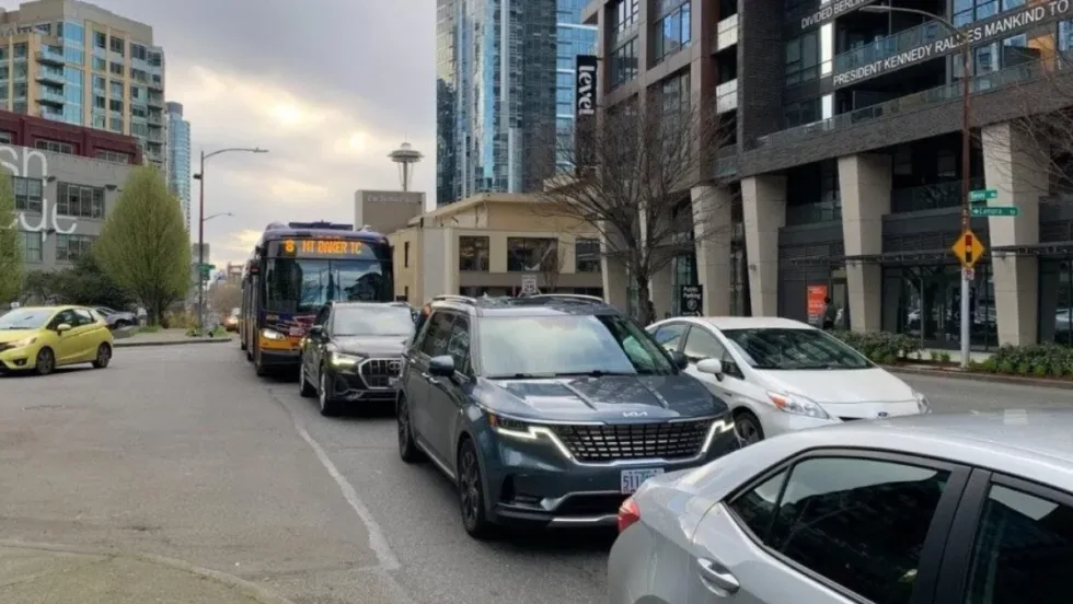 A Route 8 bus travels on Denny Way in congested traffic.