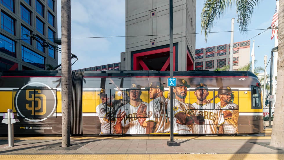 A San Diego Metropolitan Transit System trolley wrapped with a Padres player advertisement.