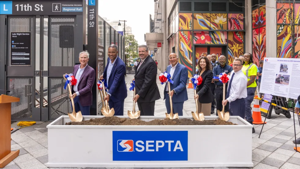 Six people hold shovels in dirt at the SEPTA 11th Street Station ground breaking.