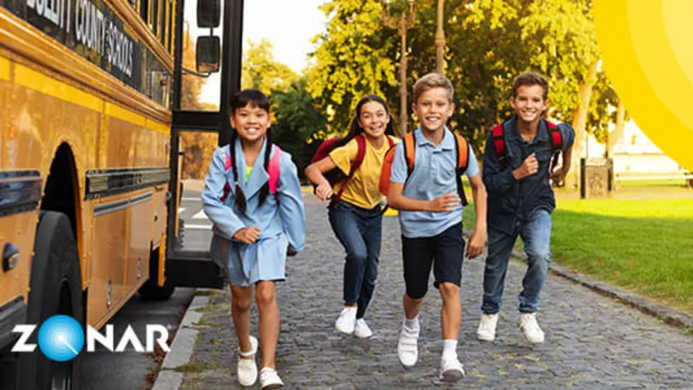 Image of happy school children exiting their school bus