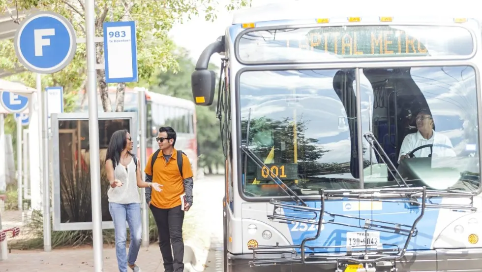 CapMetro customers at a bus stop/