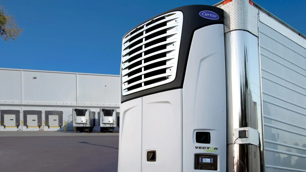 Carrier Transicold electric transport refrigeration unit on stationary trailer with loading docks in the background