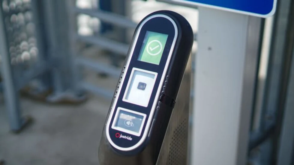 An image of a ticket validator in front of a security gate.