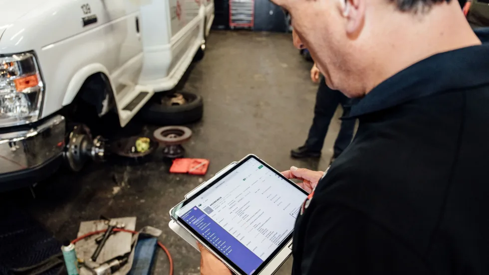 A maintenance person with a tablet.