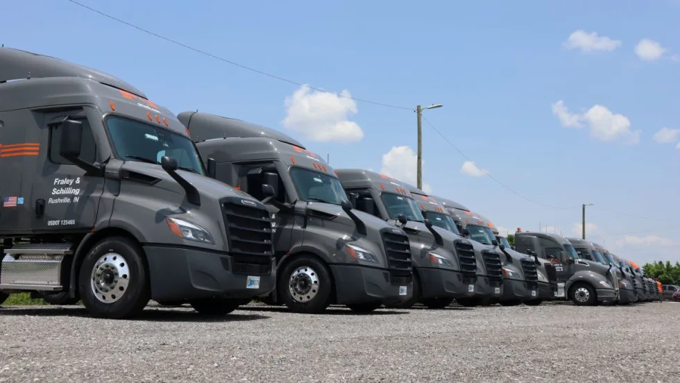 Line of gray semi trucks with Fraley & Schilling logo