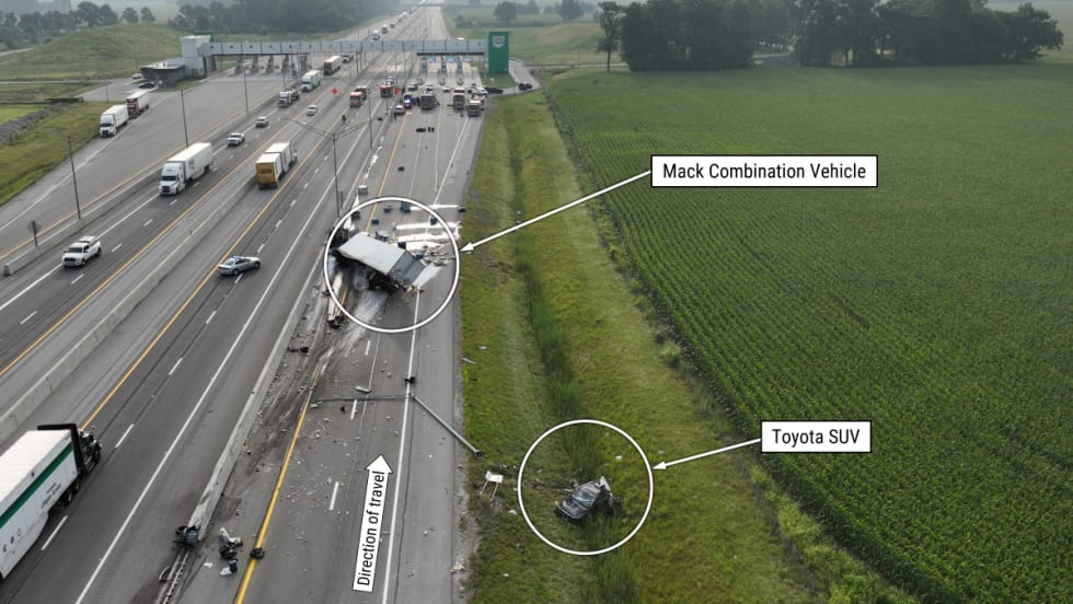 View of the crash scene with the crash location, high- and low-speed lanes, direction of travel, gore area, and concrete barrier annotated
