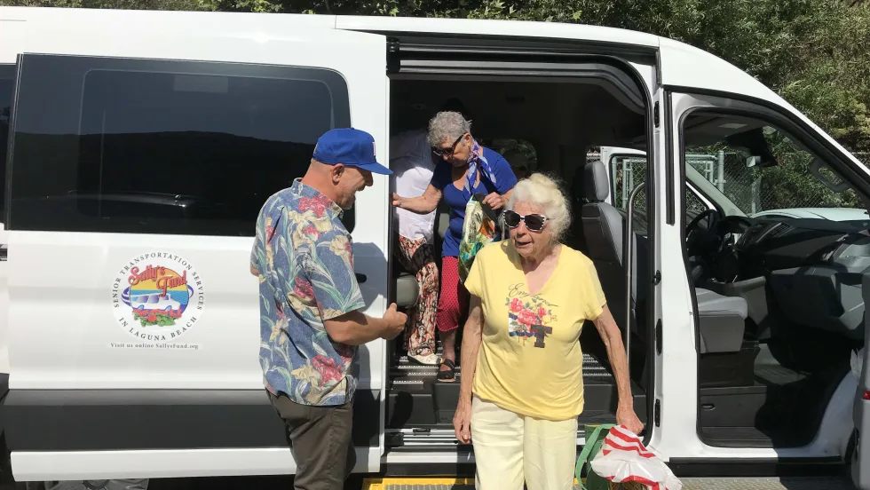Seniors exiting an OCTA van.