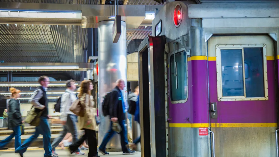 MBTA rail platform with people walking by.