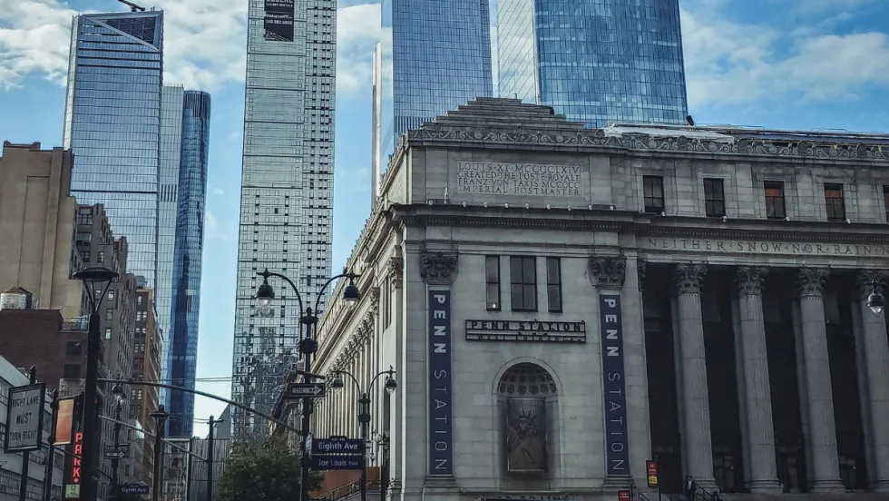 A scene of Penn Station with Hudson Yards skyscrapers in the background in New York City.