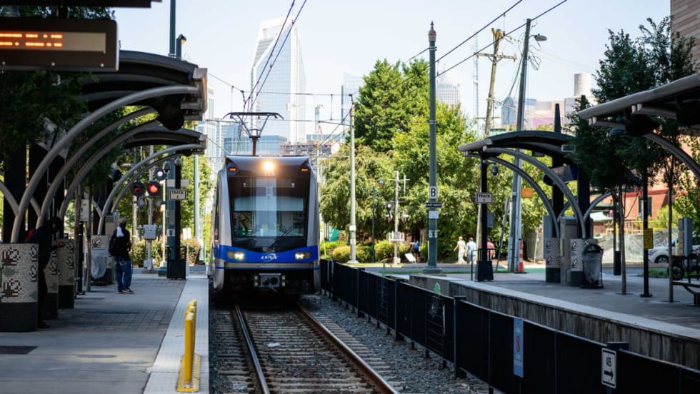 Charlotte Area Transit System's light rail pulling in to a station.