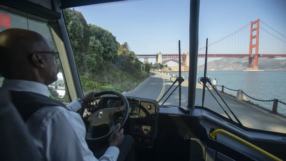 An operator driving an MCI coach in San Francisco.