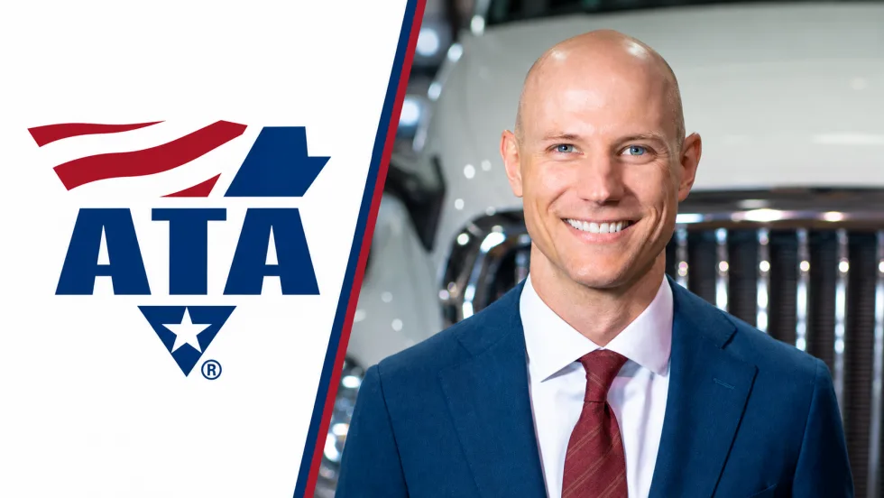 Headshot of Mark Colson in front of a truck grille next to an American Trucking Associations logo