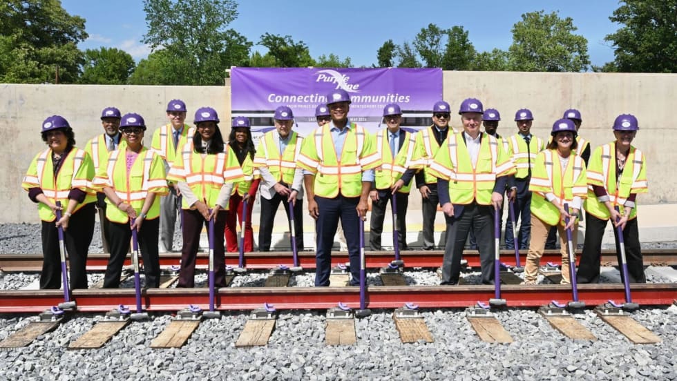 Governor Moore in a ceremony placing the last track