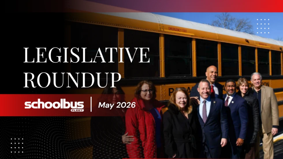 A group of people in business attire pose for a photo in front of a school bus, with text reading "Legislative Roundup: May 2026."