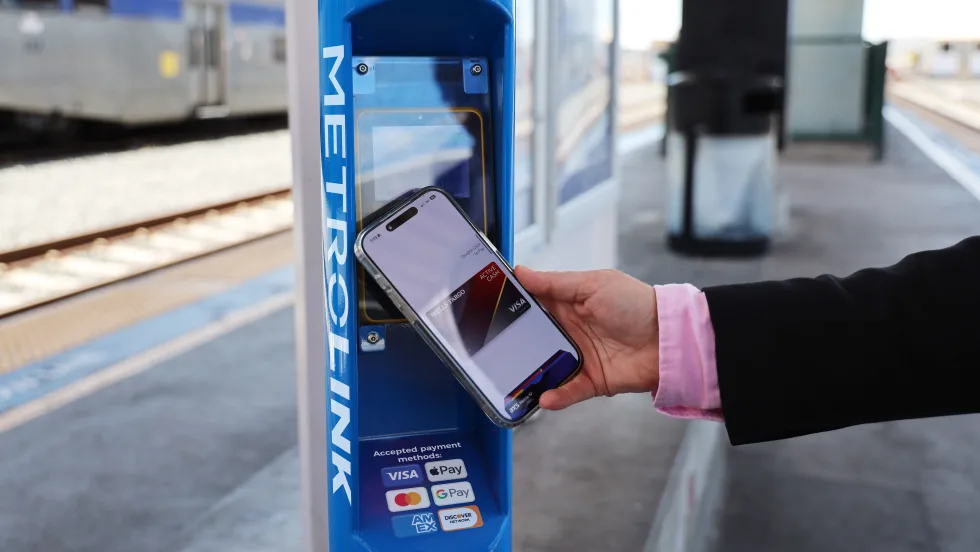 A user demonstrating Metrolink's contactless fare payment pilot.