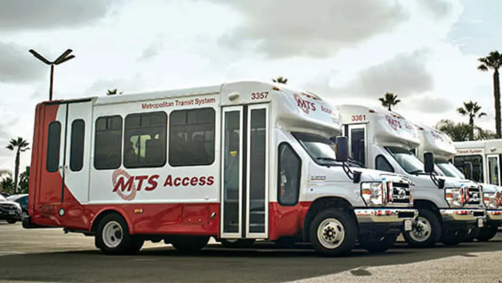 A lineup of four public transit vehicles.