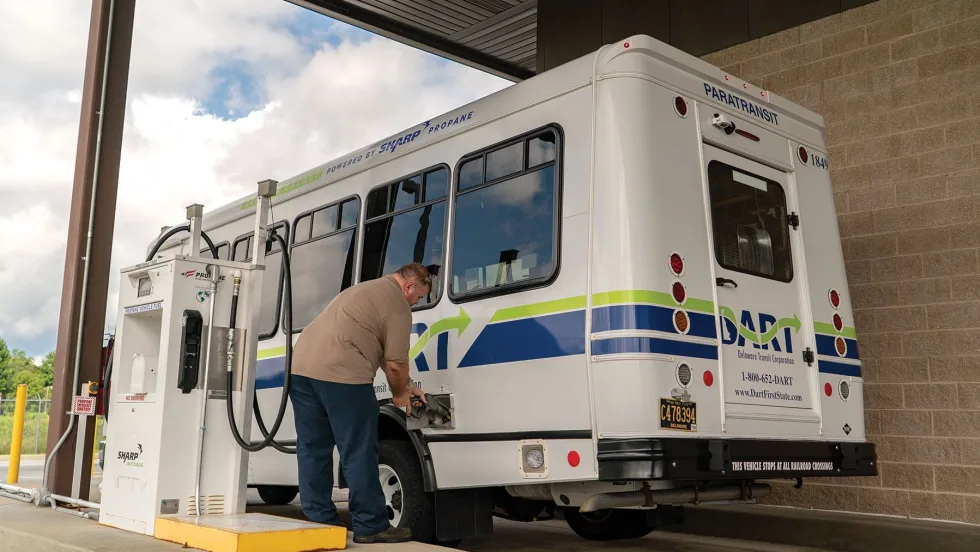 A paratransit vehicle being fueled